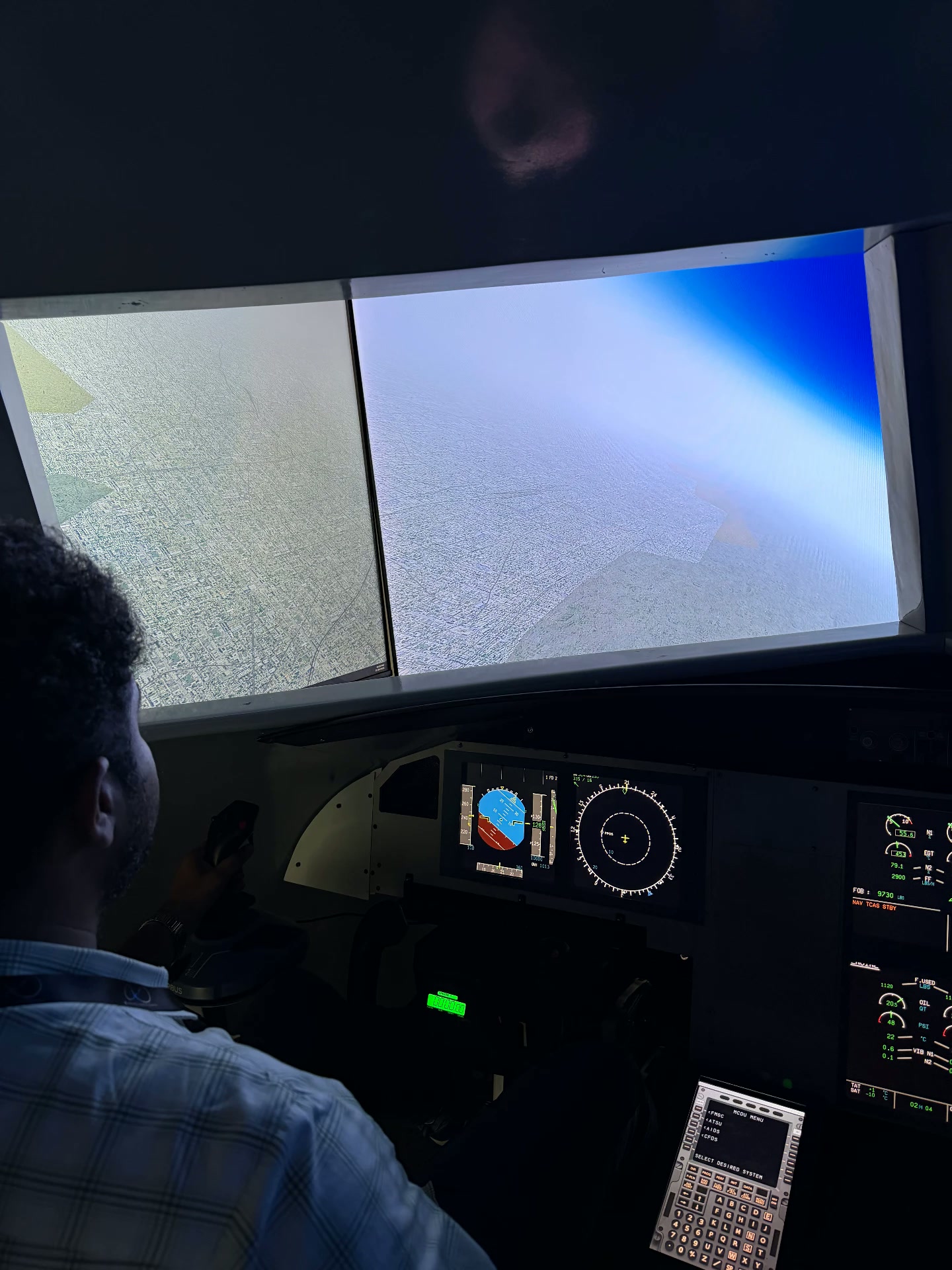 Descending over a city through the simulator's wraparound windows